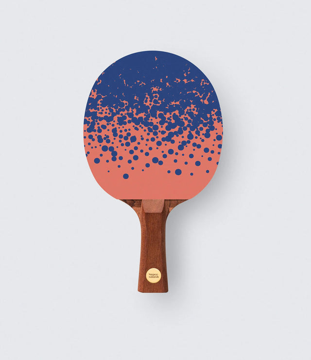 Table tennis paddle with a blue and pink gradient design on a white background