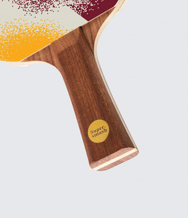 Wooden paddle with 'Supersmash' branding on a light gray background