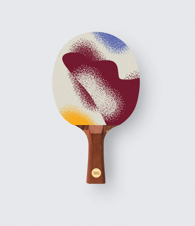 Colorful ping pong paddle with a gradient design on a white background